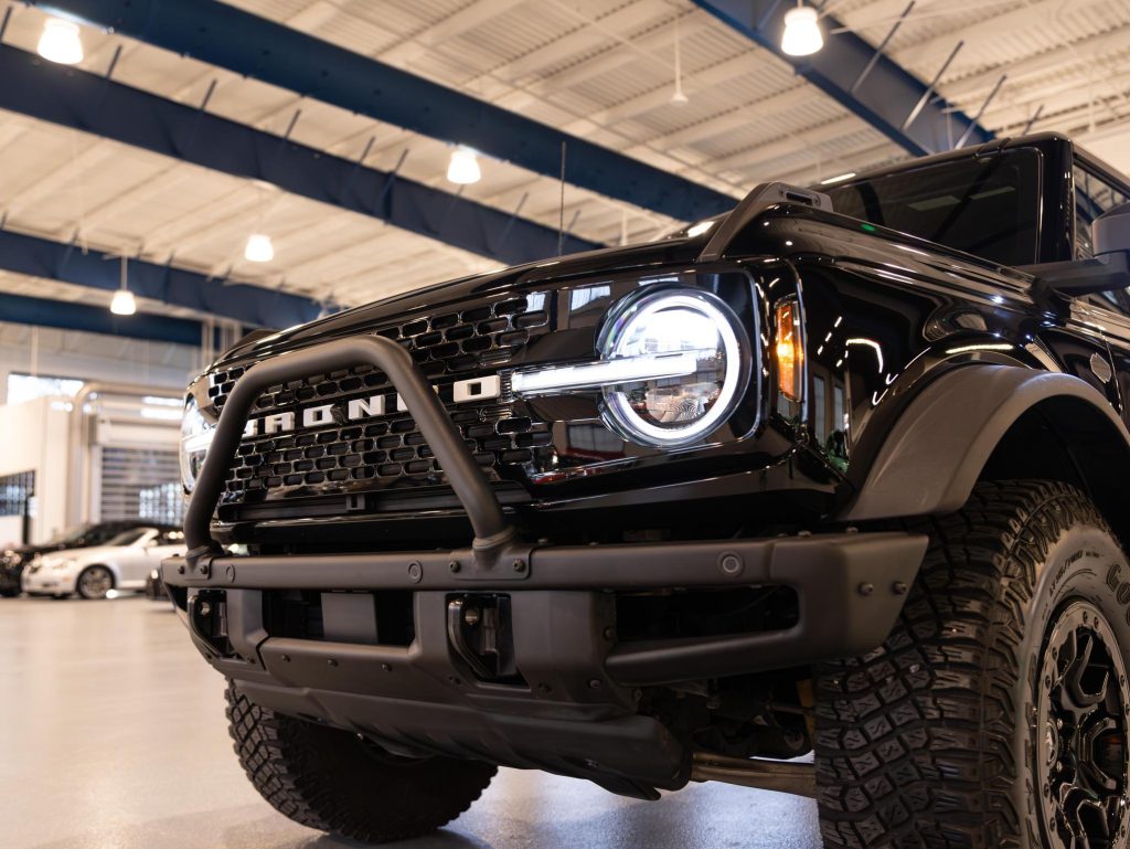 Close-up of a black ford bronco in a showroom. - Monarch Showroom
