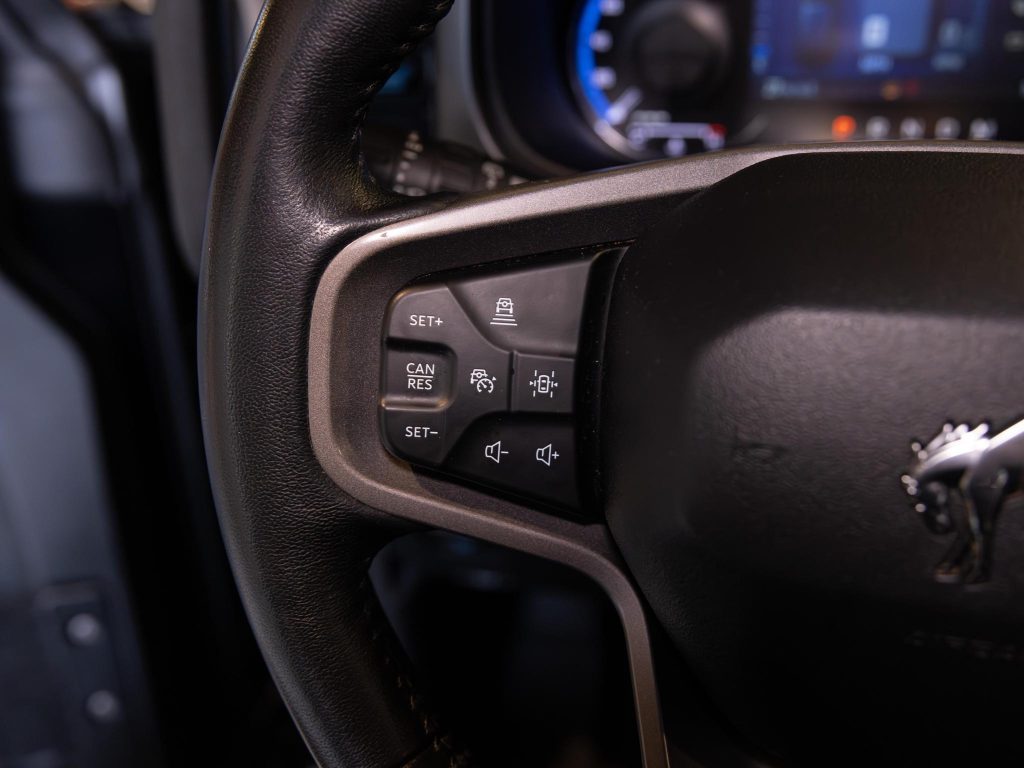 Steering wheel with mounted cruise control buttons. - Monarch Showroom