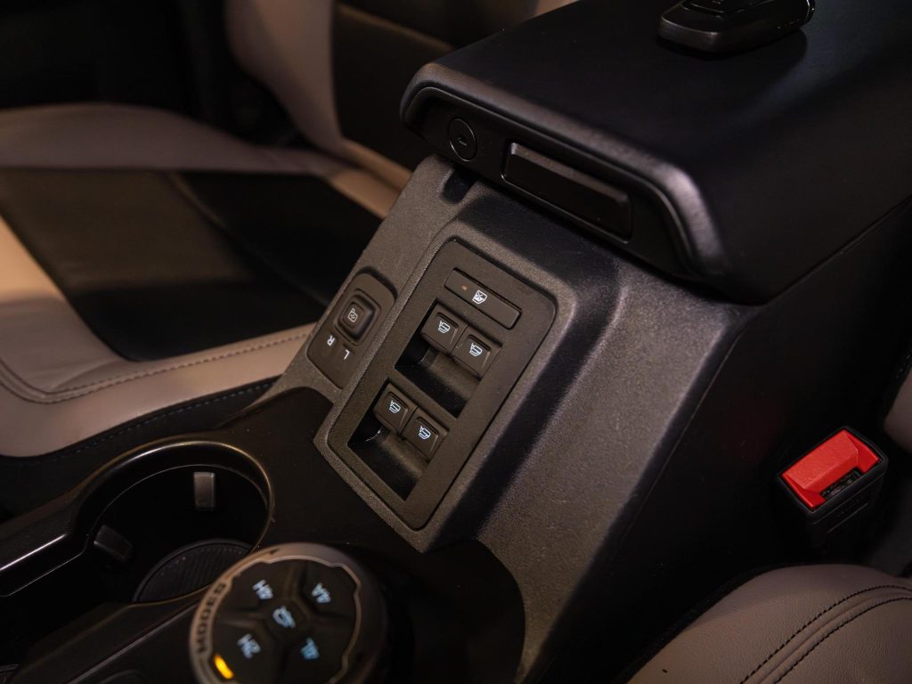 Interior of a vehicle showcasing the center console with seat adjustment controls. - Monarch Showroom