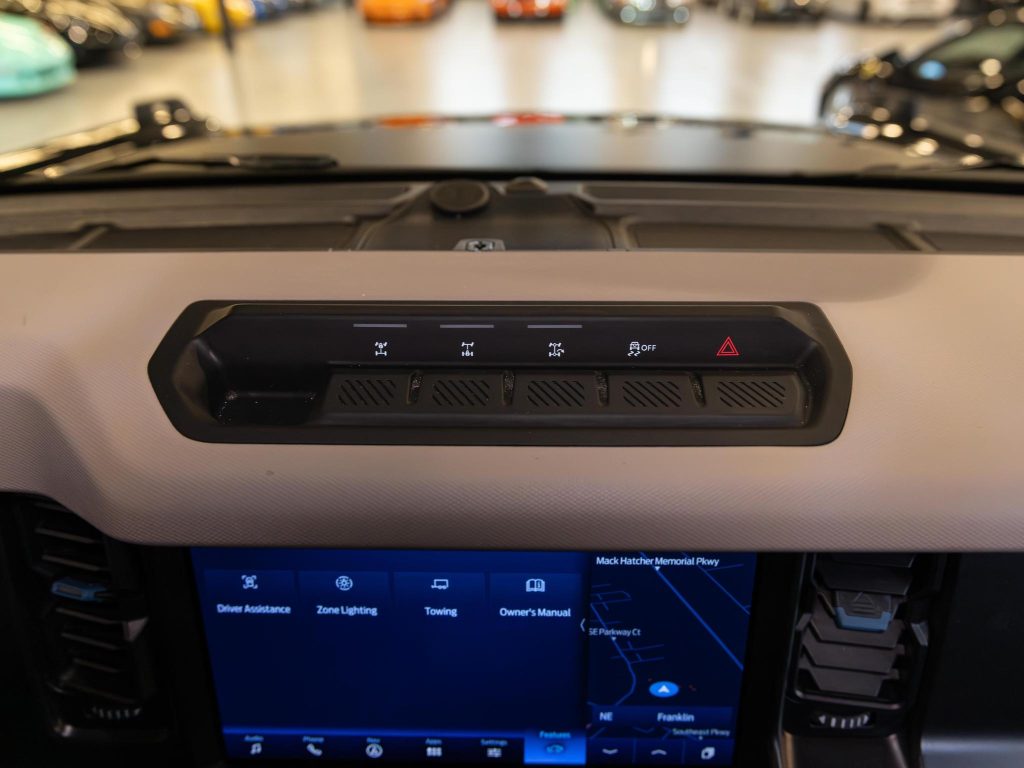 Dashboard of a modern car with a touchscreen infotainment system and air vents. - Monarch Showroom