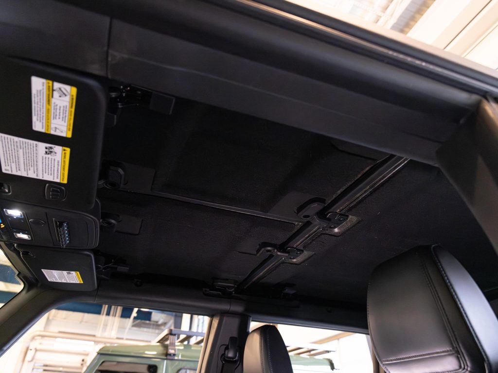 Interior view of a car showing an open sunroof and upper console from the driver's perspective. - Monarch Showroom
