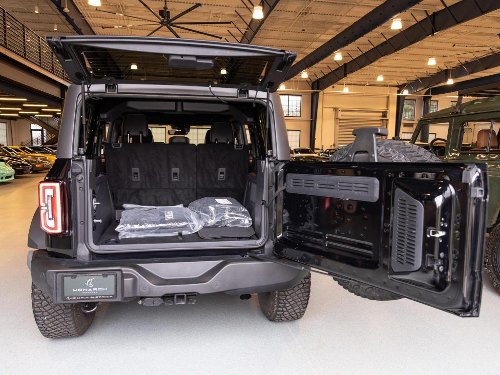 A vehicle with its rear hatch open, displaying the interior cargo space in an indoor showroom. - Monarch Showroom