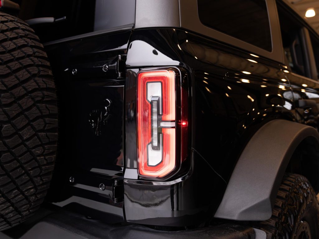 Close-up of a modern suv's rear light and spare tire mount. - Monarch Showroom