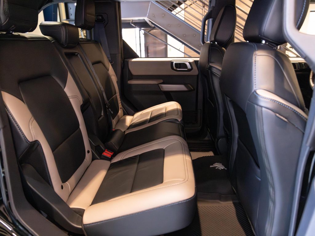 Luxury vehicle interior showing two-tone leather rear seats with a modern design. - Monarch Showroom