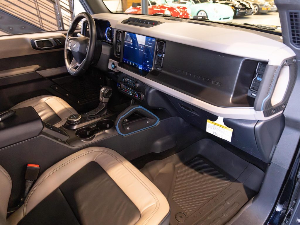 Interior of a modern vehicle showcasing the dashboard, center console, and infotainment system. - Monarch Showroom