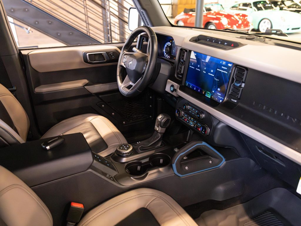 Modern vehicle interior showcasing a sleek dashboard, infotainment system, and automatic gear shift. - Monarch Showroom