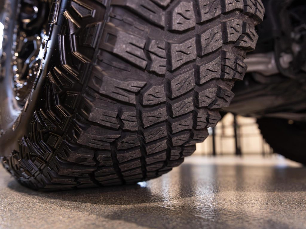 Close-up of a rugged tread on a vehicle's tire indicating off-road capability. - Monarch Showroom