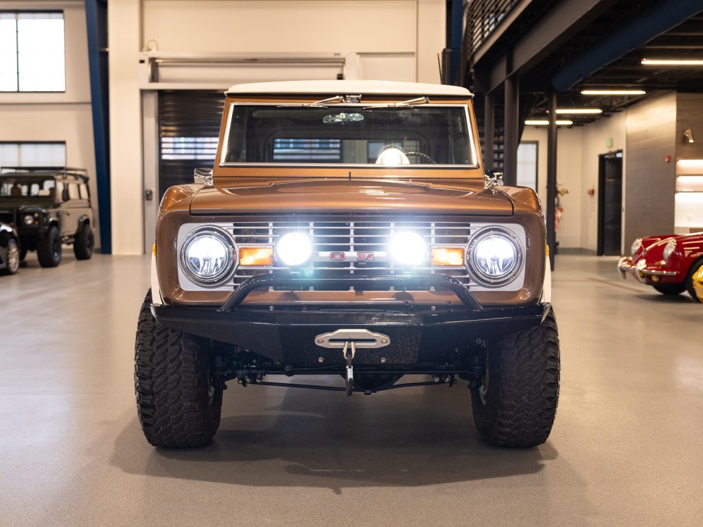 A vintage suv with off-road capabilities parked indoors, showcasing its front grille and round headlights. - Monarch Showroom