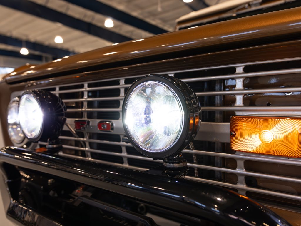 Close-up of a vintage car's front grille and headlights. - Monarch Showroom