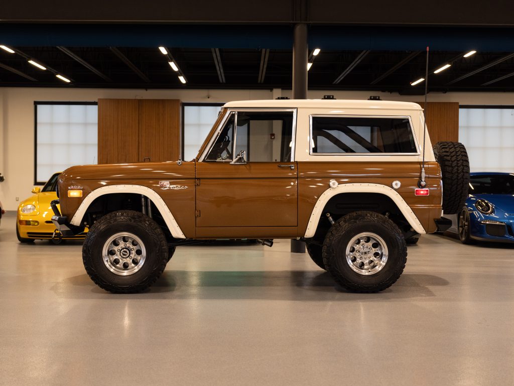 Vintage brown suv on display in an indoor showroom. - Monarch Showroom