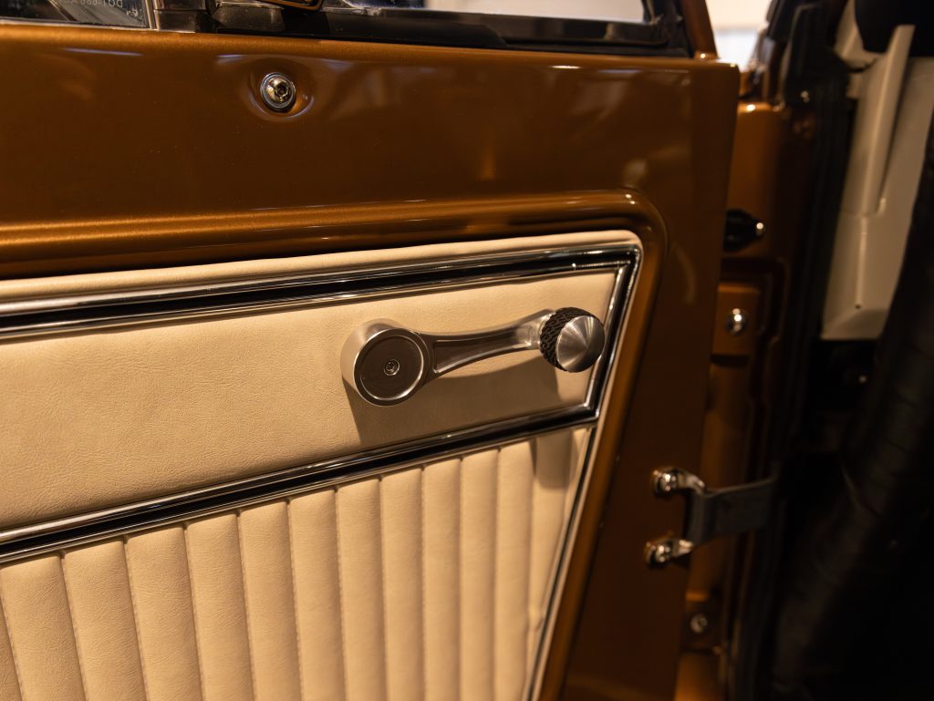 Vintage car door interior with manual window crank handle. - Monarch Showroom