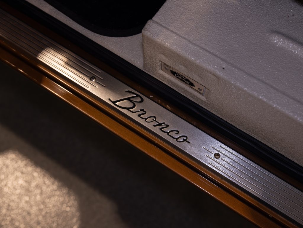 Close-up of a ford bronco vehicle's door sill with the "bronco" logo engraved on it. - Monarch Showroom