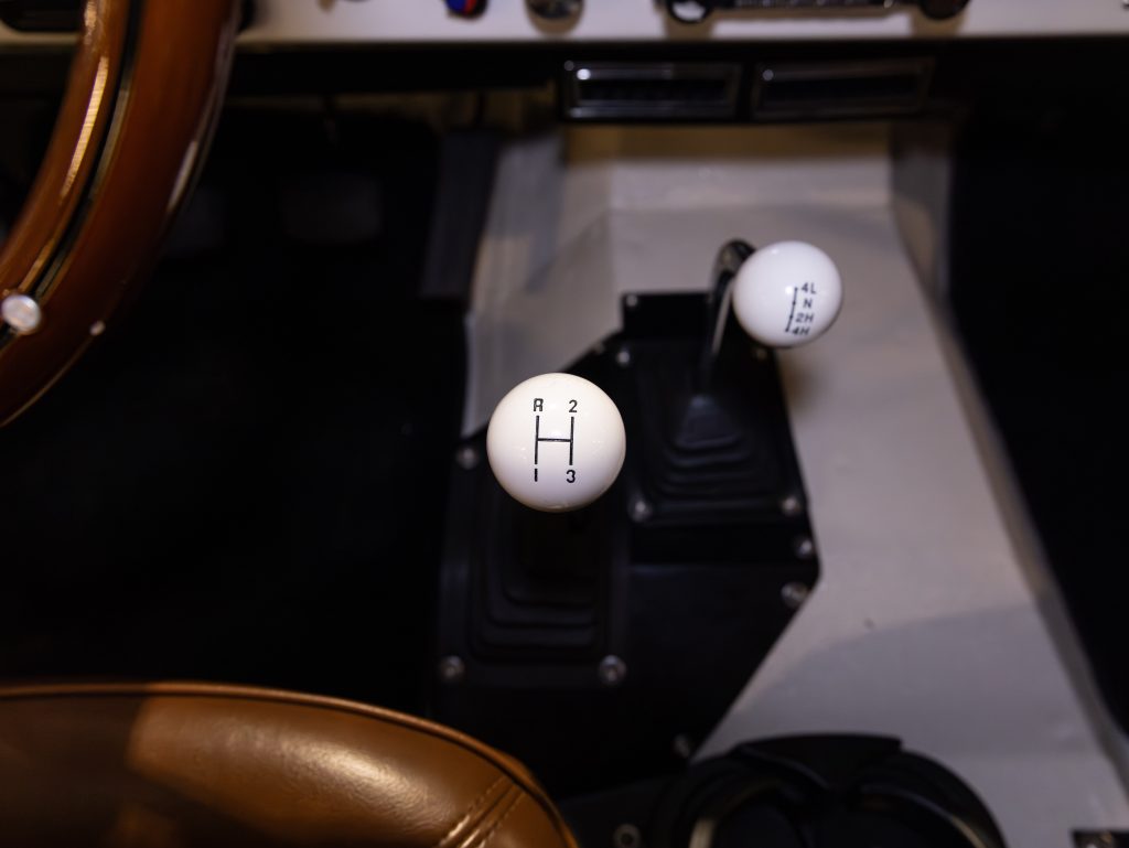 Interior view of a vehicle showing a manual transmission shifter. - Monarch Showroom