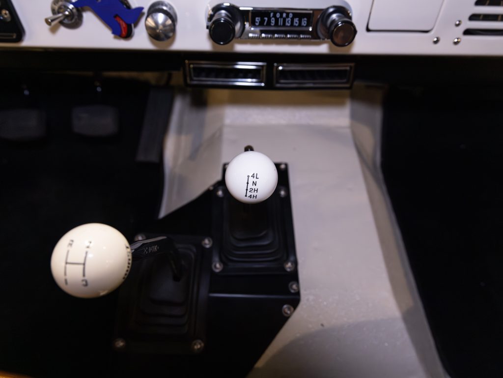 Gear shift levers and dashboard controls inside a vehicle. - Monarch Showroom