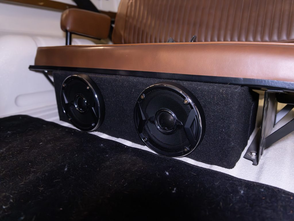 Custom car audio installation with two speakers mounted under a bench seat. - Monarch Showroom