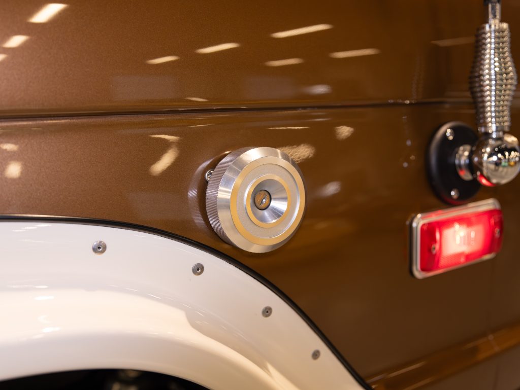 Close-up of a vintage car's fuel cap and tail light. - Monarch Showroom