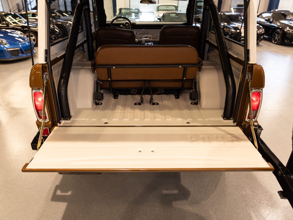 Rear view of a vehicle with its tailgate open, showcasing a clean, empty cargo space and a folded bench seat. - Monarch Showroom