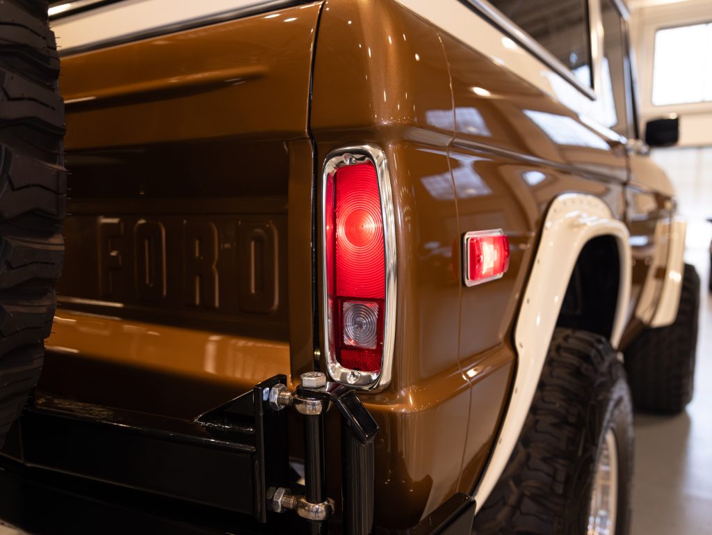 Close-up of a vintage ford bronco's rear side panel and taillight. - Monarch Showroom