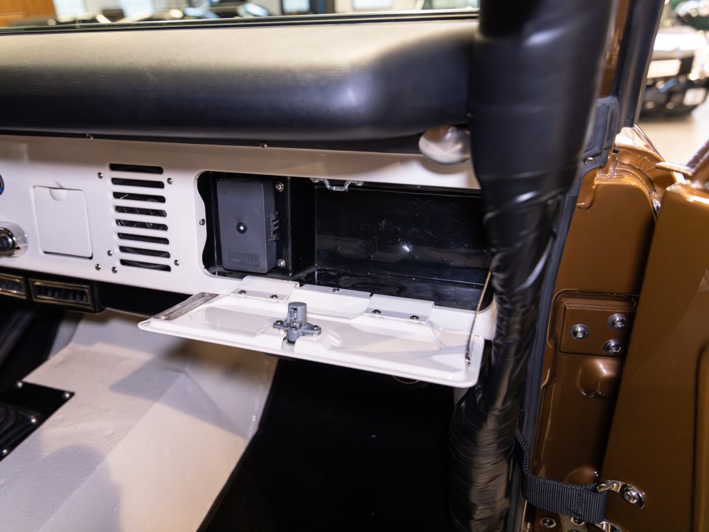 Open glove compartment in a vintage car interior. - Monarch Showroom