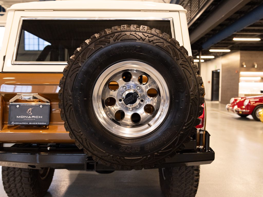 Rear view of a classic suv with a spare tire mounted on the back. - Monarch Showroom