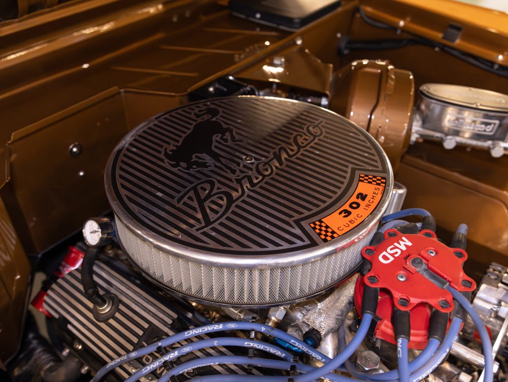 Vintage ford bronco engine with an aftermarket air cleaner and performance parts. - Monarch Showroom