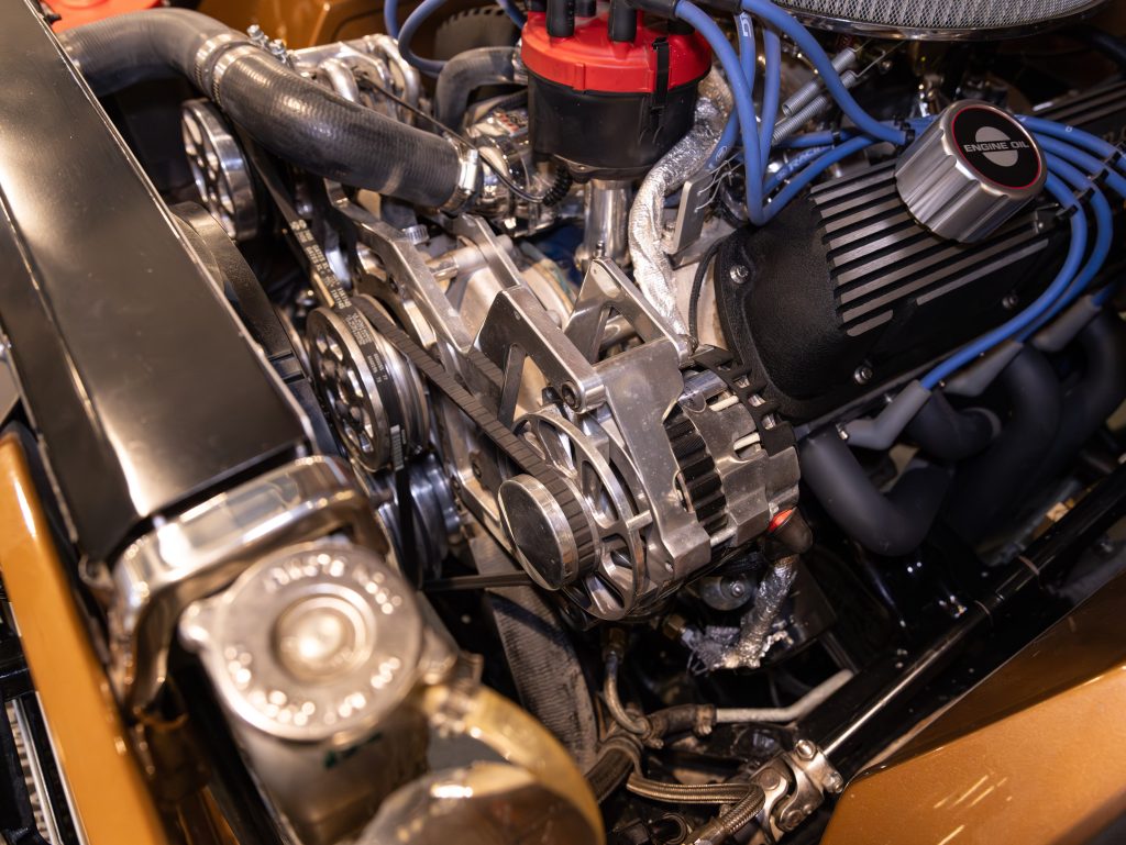 Close-up of a car engine showing belts, pulleys, and chrome components. - Monarch Showroom