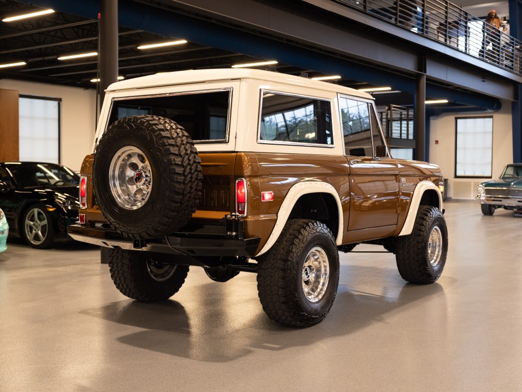 A vintage brown suv showcased in an indoor facility. - Monarch Showroom