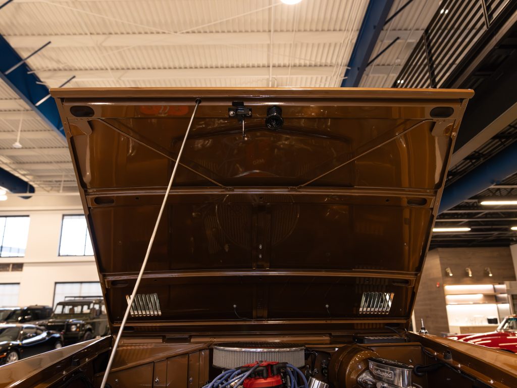 Open hood of a vintage car revealing the engine bay. - Monarch Showroom