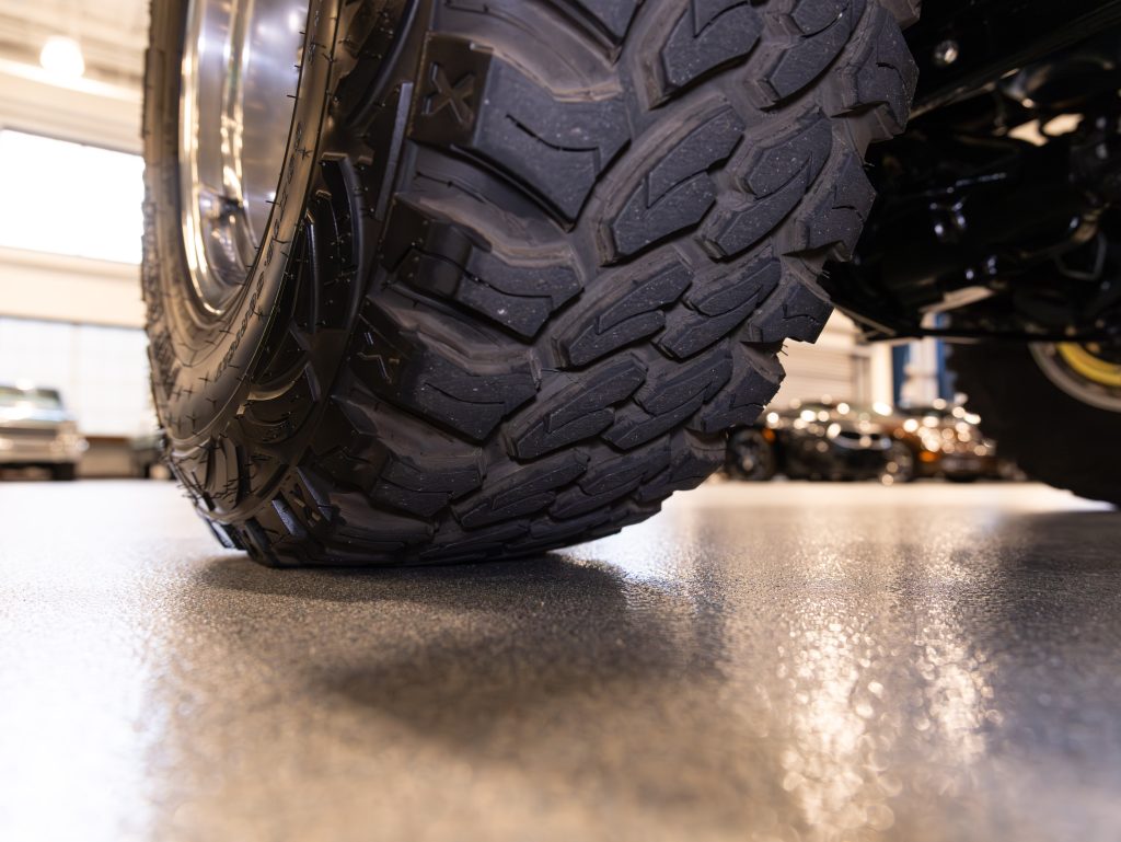 Close-up view of a motorcycle tire with tread detail, situated in a showroom setting. - Monarch Showroom