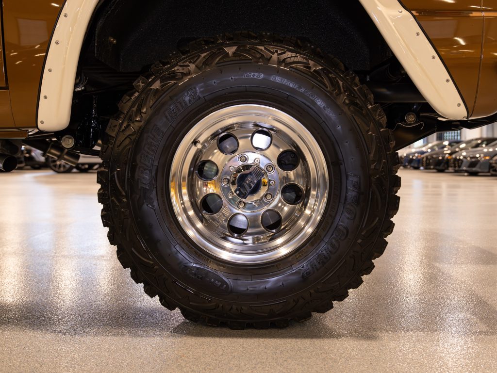 Polished chrome wheel on an off-road vehicle with visible tread detail. - Monarch Showroom