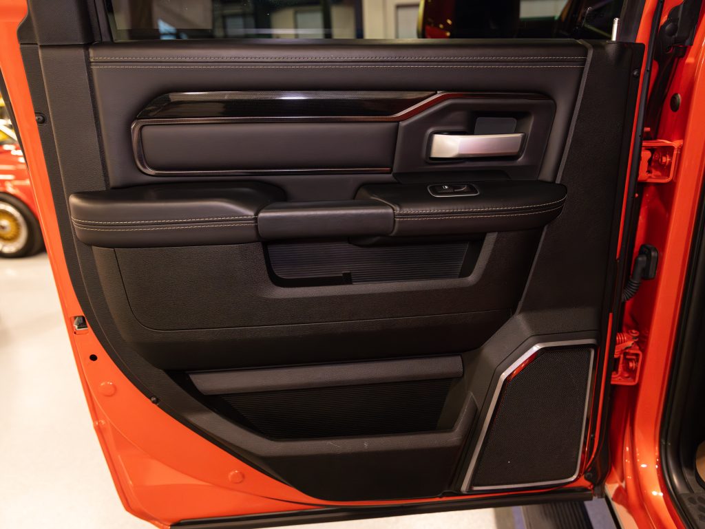Black and red car door interior with storage compartments and controls. - Monarch Showroom