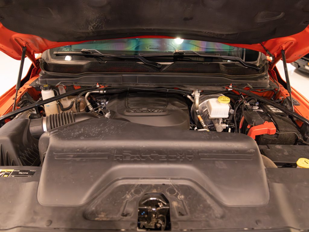 An open car hood revealing a modern vehicle's engine compartment. - Monarch Showroom