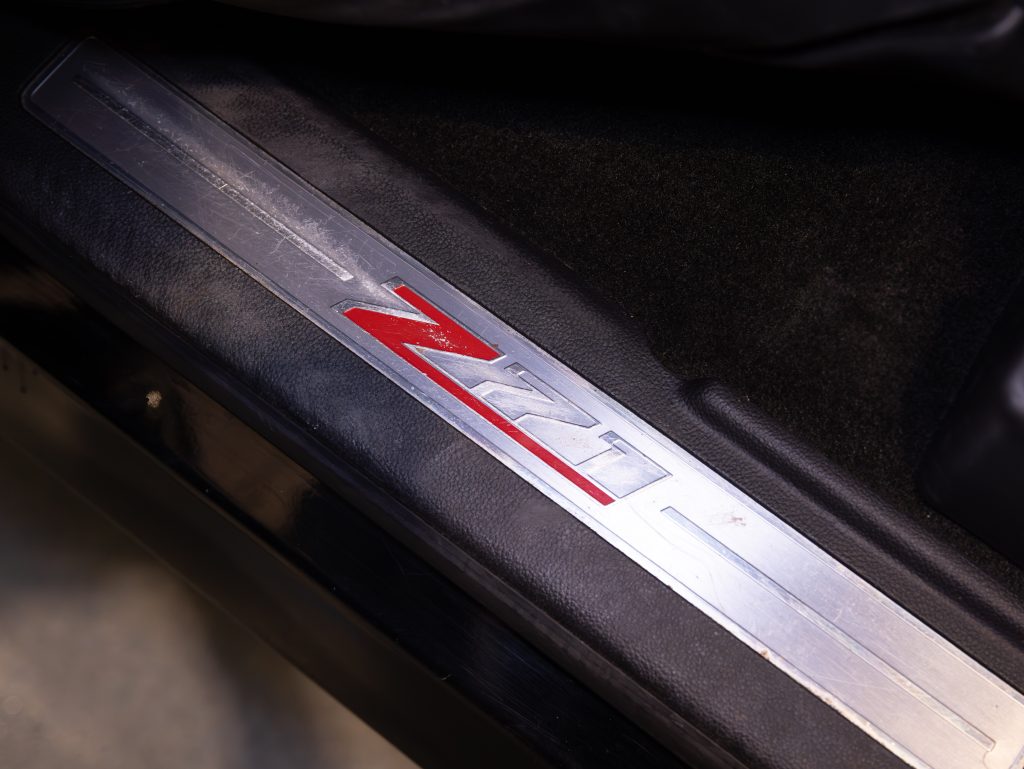 Close-up of a metallic car door sill plate featuring the red and silver "Z71" logo on a black surface. - Monarch Showroom